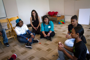 Group of young women of color talking about sexual health
